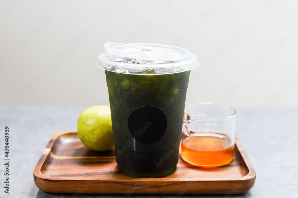Iced green tea mixed honey lemon in plastic cup. Iced green tea mixed honey lemon in plastic cup.