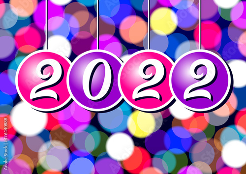 The inscription 2022 on balls on the background of multicolored background consisting of a circles