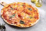 Freshly baked traditional mediterranean pizza with tomato sauce marinara, mozzarella cheese, pork sausage salsiccia and basil