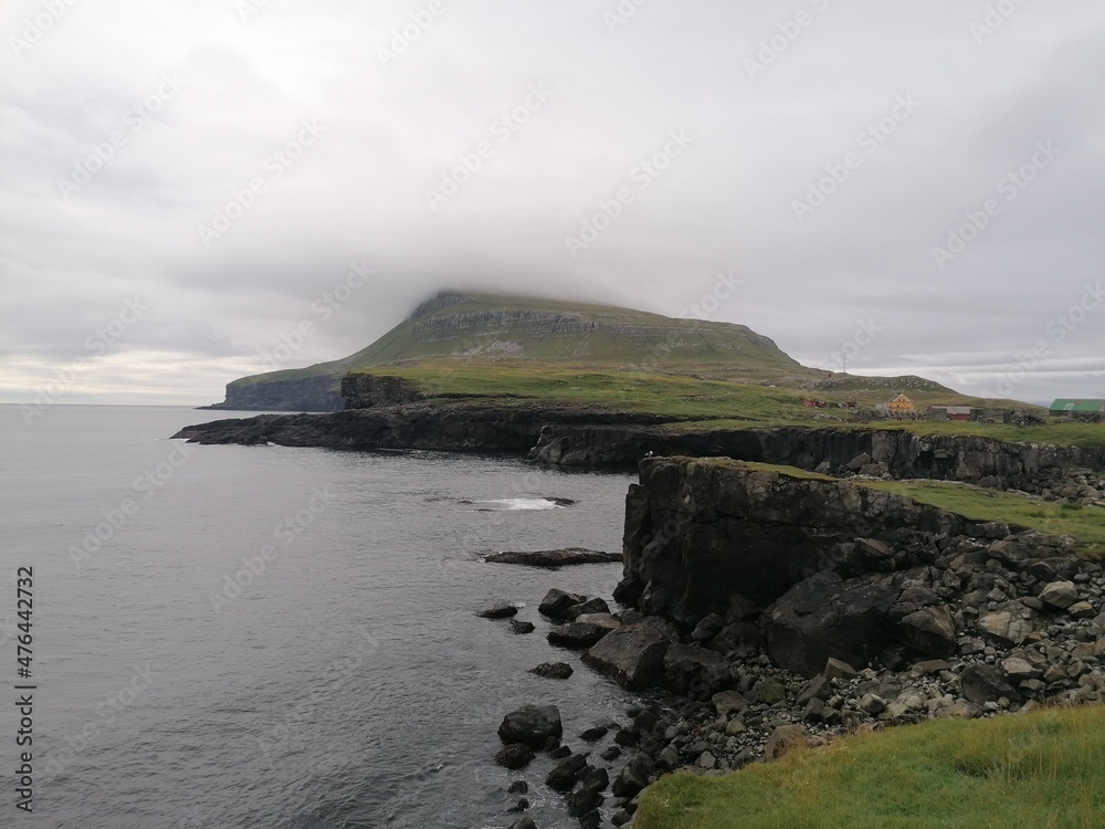 Dramatic cliffs, mountains and coastline on the lush Faroe Islands in the Atlantic Ocean