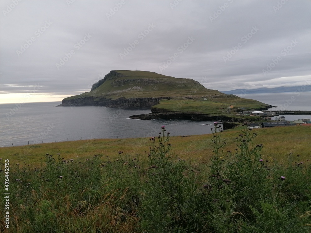 Dramatic cliffs, mountains and coastline on the lush Faroe Islands in the Atlantic Ocean