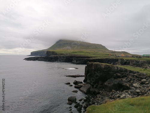 Dramatic cliffs, mountains and coastline on the lush Faroe Islands in the Atlantic Ocean © ChrisOvergaard