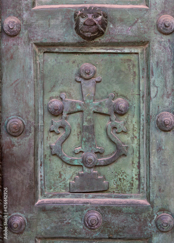 Copper christian door symbol bas relief background texture.