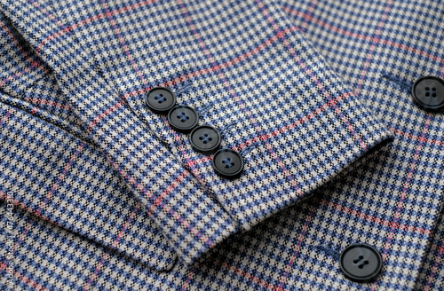 Buttons placed on a sleeve of jacket. Close up image