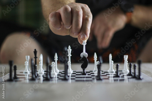 Valokuvatapetti hand rearranging chess on the chessboard
