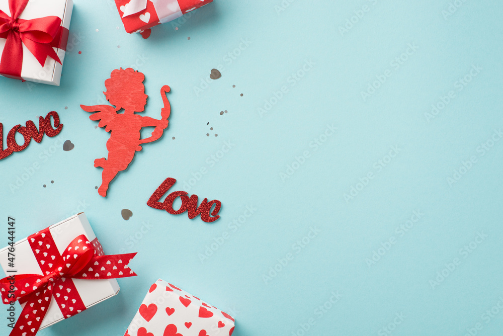 Fototapeta premium Top view photo of st valentine's day decorations gift boxes heart shaped confetti sequins inscriptions love and red cupid silhouette on isolated pastel blue background with copyspace
