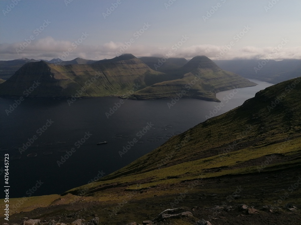 Stunning mountain views in the green and lush hills of the Faroe Islands in the Atlantic Sea