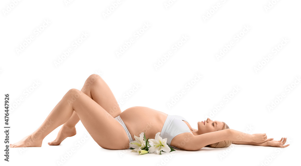 Beautiful pregnant woman with lily flowers lying against white background Beautiful pregnant woman with lily flowers lying against white background