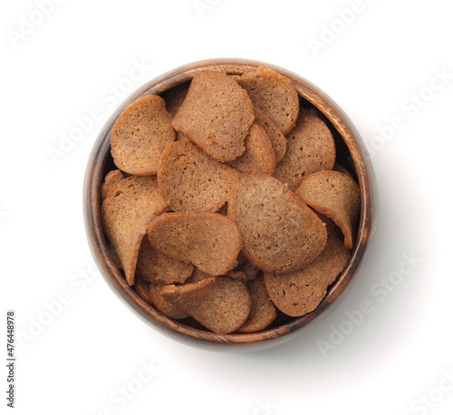 Top view of rye bread chips in wooden bowl