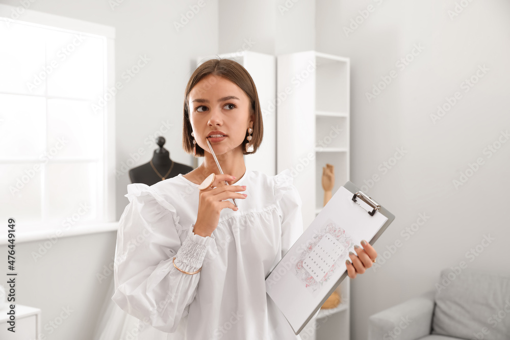Female wedding planner with Save the Date Announcement in office Female wedding planner with Save the Date Announcement in office