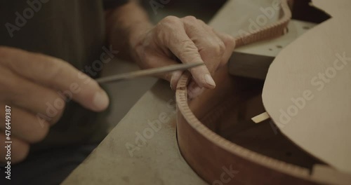 Luthier filing cracks in a guitar mold photo