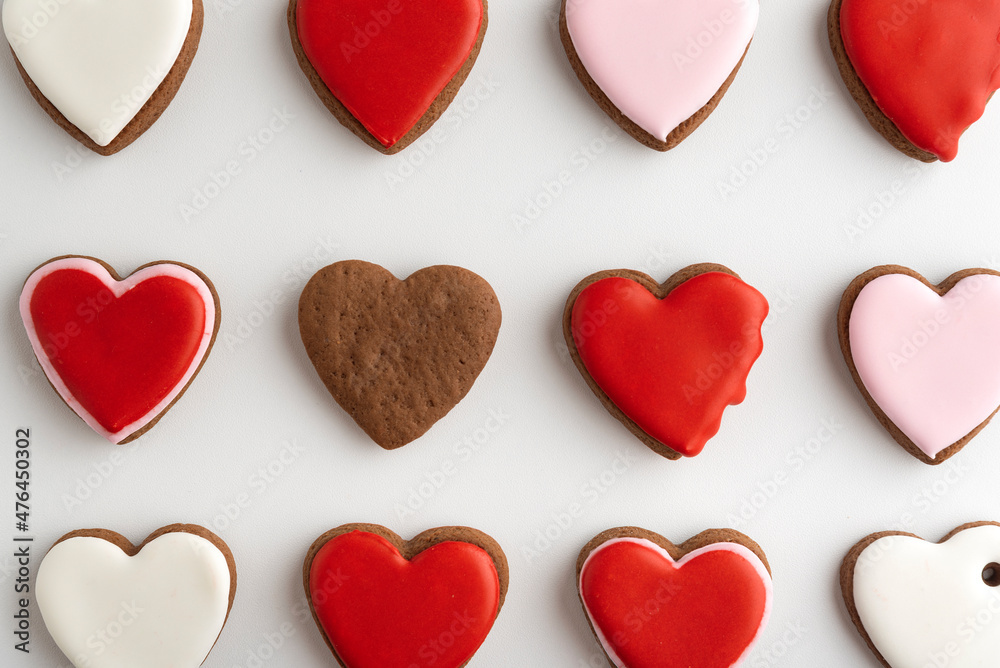 Background from many hearts shaped gingerbread. Close up. Valentines Day, white background. Mothers day. Background from many hearts shaped gingerbread. Close up. Valentines Day, white background. Mothers day.