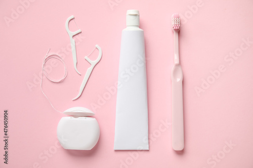 Obraz na plátně Dental floss, toothpicks, paste and brush on pink background