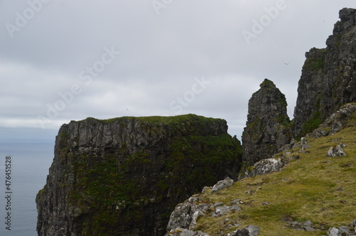 The green and blue dramatic and wild coastal landscapes in the Faroe Islands