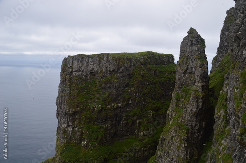 The green and blue dramatic and wild coastal landscapes in the Faroe Islands