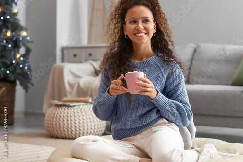 Pretty young woman with cup...