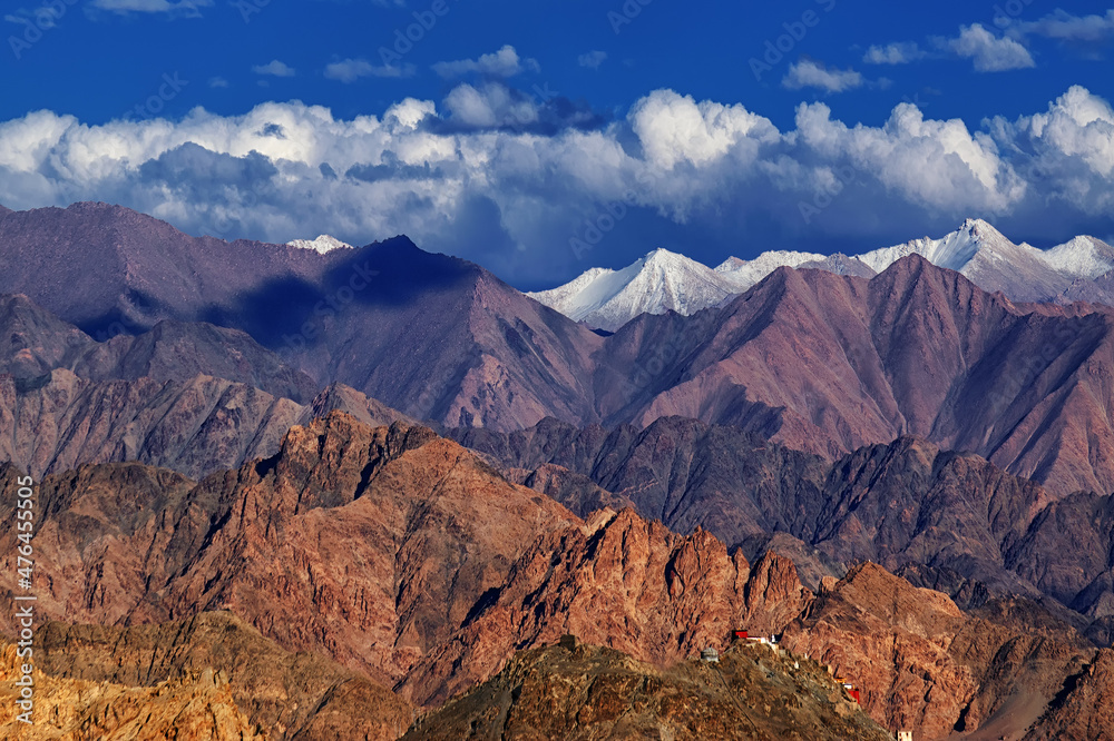 Rocky landscape with ice peaks and blue cloudy sky in background , Ladakh, Jammu and Kashmir, India