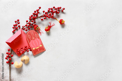 Red envelopes with Chinese symbols on light background. New Year celebration photo