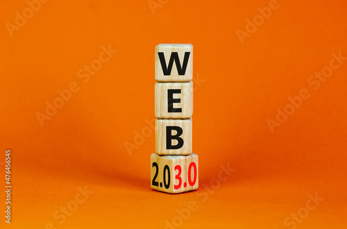 WEB 2.0 or 3.0 symbol. Turned a wooden cube and changed words WEB 2.0 to WEB 3.0. Beautiful orange table, orange background, copy space. Business, technology and WEB 2.0 or 3.0 concept.