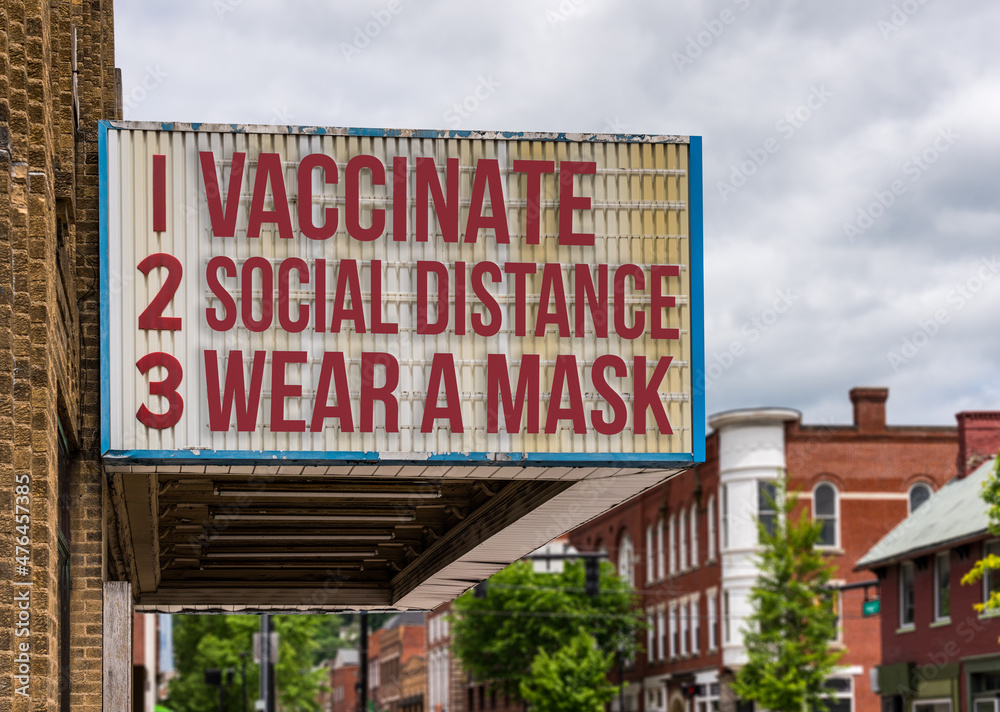 Mockup of movie cinema billboard with vaccinate, wear a mask, social distance to deal with the omicron variant of Covid-19 coronavirus epidemic