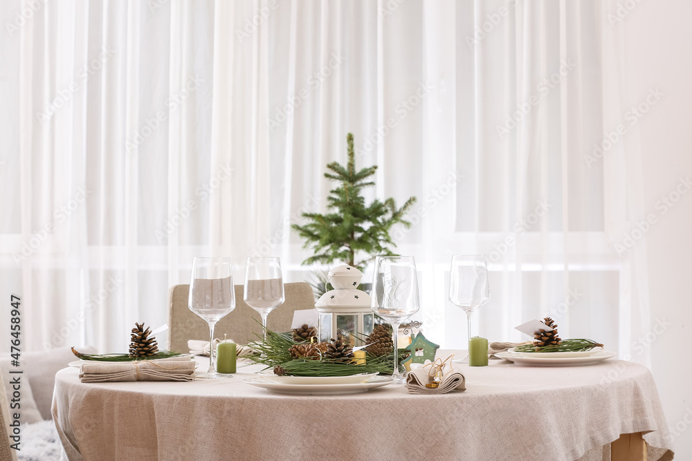 Beautiful table setting with pine cones and fir branches indoors Beautiful table setting with pine cones and fir branches indoors