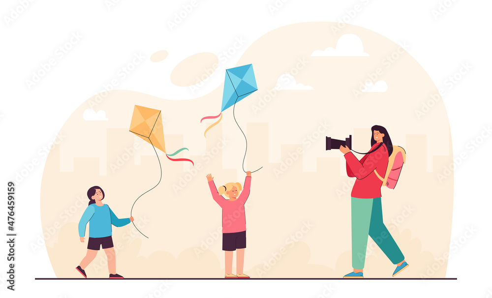 Mother taking picture of daughters playing game with kites. Woman holding photo camera flat vector illustration. Summer adventure, vacation concept for banner, website design or landing web page