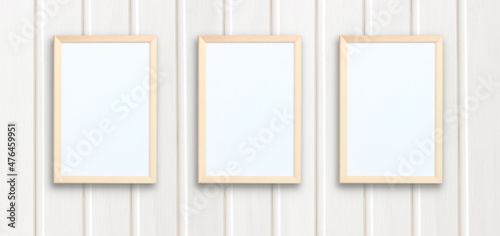 layout of three wooden frames on a white wooden wall.