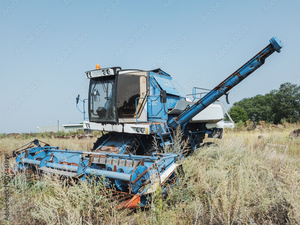 Old combine harvester abandoned in the field.