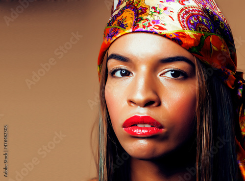 beauty bright real african woman with creative make up, shawl on head like cubian closeup smiling photo