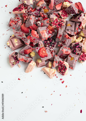 Crushed chocolate bar with berries and nuts with space for text. Topview photo