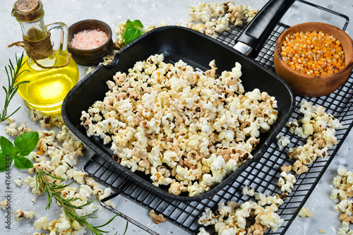 Salted popcorn in a metal pan. Top view. Rustic style.