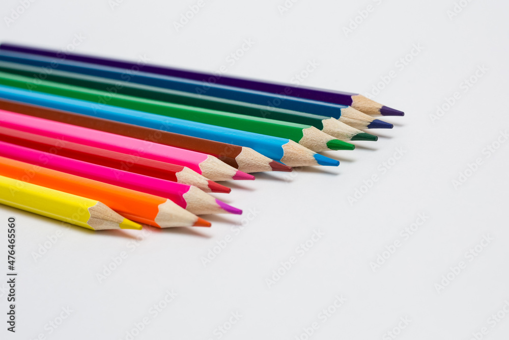 Assortment of coloured pencils on white background. Painting supplies.

