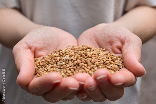 Buckwheat in the hands. The concept of healthy eating.
