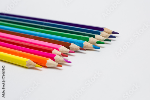 Assortment of coloured pencils on white background. Painting supplies. 