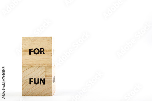Wooden cubes with the inscription for fun on a white background close up