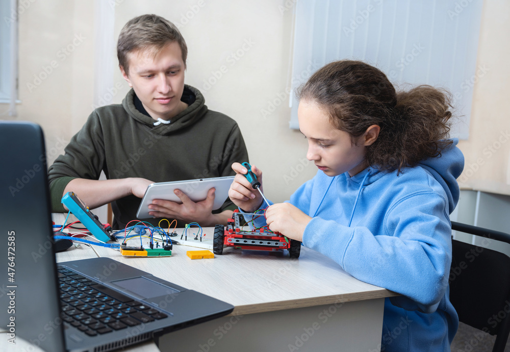 Learn new stuff about mechanics and robotic. School children are working on school assignment Learn new stuff about mechanics and robotic. School children are working on school assignment