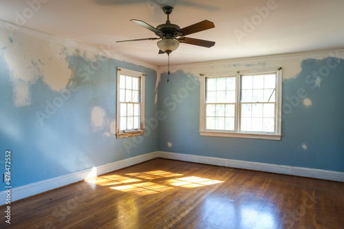 Empty Residencial Bedroom in the Middle of Renovation with Walls that Need to be Painted