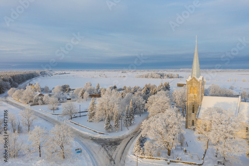 Aerial view of the Church of the Blessed Virgin Mary in Joelahtme (Estonian - Püha Neitsi Maarja kirik, Jõelähtme) on a sunny winter morning. One of the oldest churches in Estonia photo