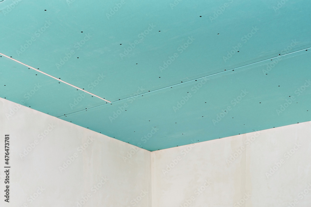 Plasterboard ceiling on an installed profile frame. Apartment or office renovation. A cheap and quick way to make a partition or ceiling in a room or warehouse.