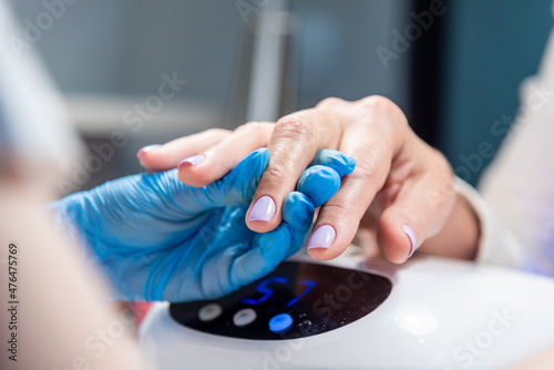 Performing manicure work in a beauty salon.