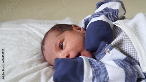The mother is changing the newborn baby's clothes. 4K