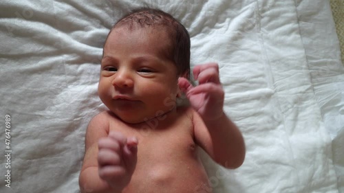 The mother is changing the newborn baby's clothes. 4K