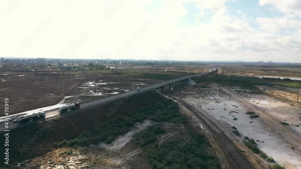 tank trucks driving across the bridge. cargo transportation. shooting from a quadcopter tank trucks driving across the bridge. cargo transportation. shooting from a quadcopter