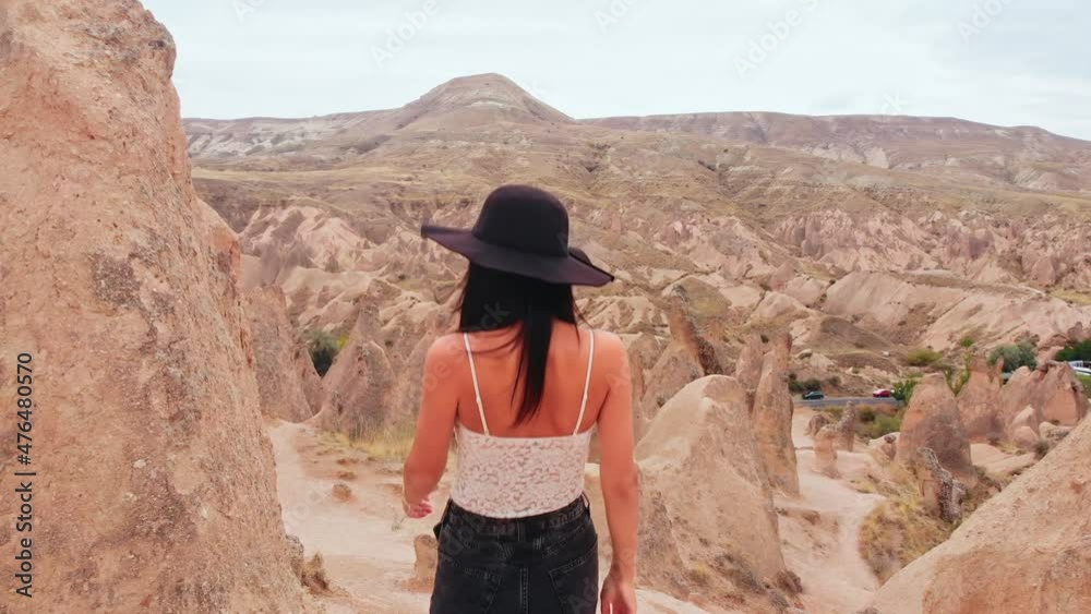 Caucasian Woman tourist enjoy freedom and travel holidays outdoors walk don among fairy chimneys in devrent valley , Cappadocia Caucasian Woman tourist enjoy freedom and travel holidays outdoors walk don among fairy chimneys in devrent valley , Cappadocia