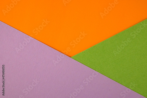 Bright abstract geometric paper background. Green, violet and orange trendy colors. The backdrop for an invitation card, greeting card or web design. Creative copy space, flat lay