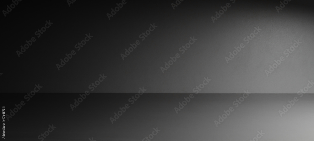Abstract gray room background with a light beam on the right side of the image. Backdrop and mockup, product presentation background. Low key Abstract gray room background with a light beam on the right side of the image. Backdrop and mockup, product presentation background. Low key