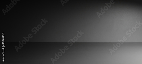 Abstract gray room background with a light beam on the right side of the image. Backdrop and mockup, product presentation background. Low key