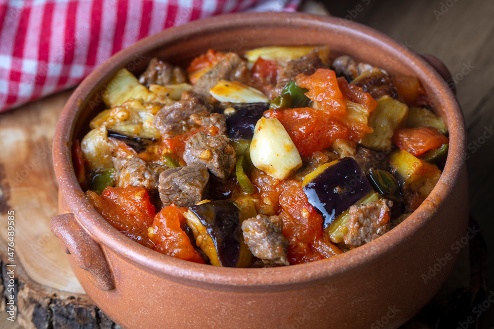 Top view of Turkish dish Guvech - baked meat with eggplant and traditionally served in earthenware pot (Turkish name; etli patlican guvec) Top view of Turkish dish Guvech - baked meat with eggplant and traditionally served in earthenware pot (Turkish name; etli patlican guvec)