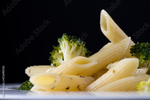 pasta with broccoli on a black background