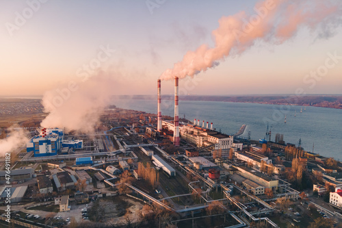 Smoking factory smokestack. Environmental problem of emission of environment and atmosphere in large cities. View of large plant with Industrial smoke pipes